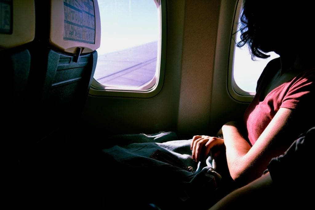 A woman sitting on an airplane.